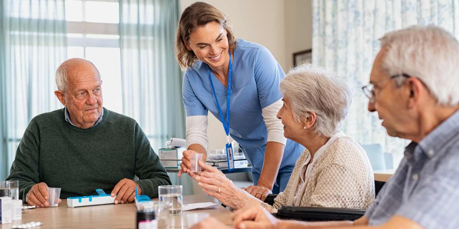 Assisted Living Facility Residents smiling and talking with staff member