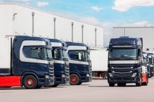 Blue Cargo Trucks Parked in Front of A Warehouse