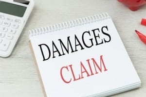 damages claims written on notepad