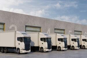 Fleet of White Trucks Parked at Warehouse