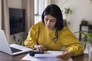 focused busy Indian freelance accountant woman checking financial documents