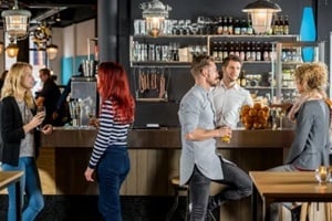 friends talking while having their drinks in bar