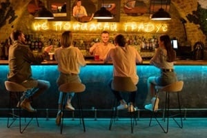glass of whiskey with ice stands on bar counter