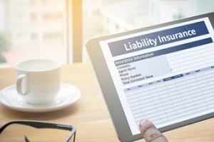 man checking liability insurance on tab