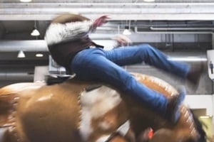 man falling from mechanical bull