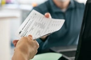 man giving health insurance form