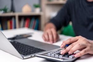 Person Calculating Cost of Assisted Living Facility Insurance