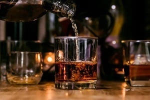 pouring whisky in glass