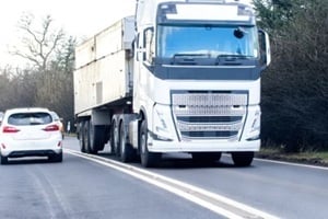 truck moving on the highway crossing a car