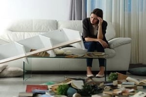 upset lady with broken house