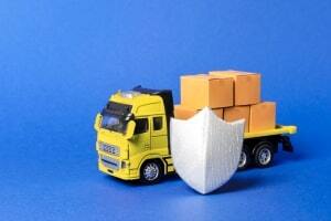 Yellow Truck with Cardboard Boxes Covered by Shield Showing Commercial Trucking Insurance Concept
