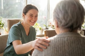 Smiling Assisted Living staff talking with female resident