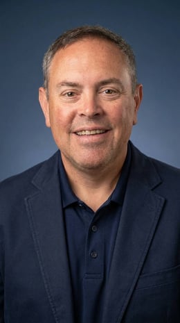 Dave Rysavy/VP of Personal Lines in a navy blue suit specializing in Personal Lines Home and Auto Insurance